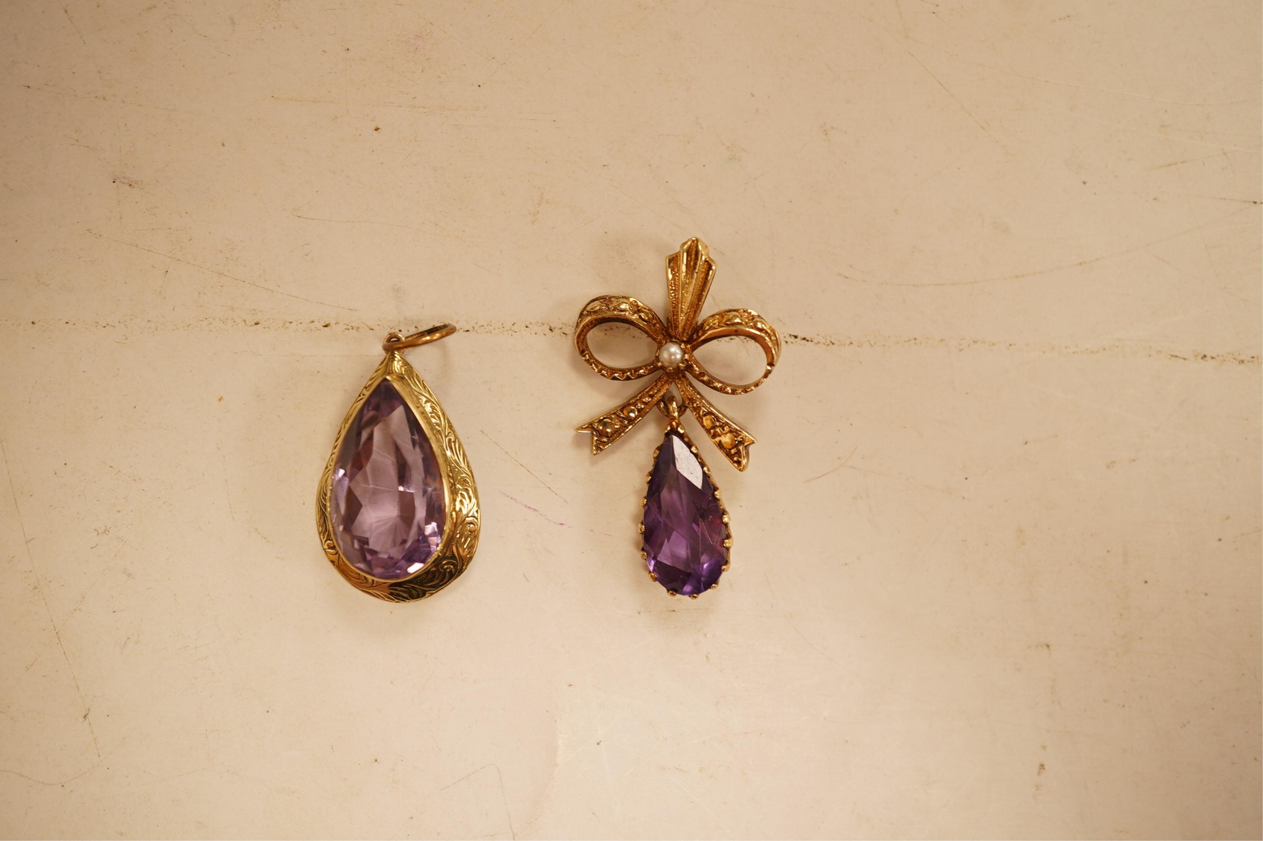 A 1970's 9ct gold, amethyst and seed pearl set drop pendant, 29mm, together with a yellow meta and amethyst set drop pendant.